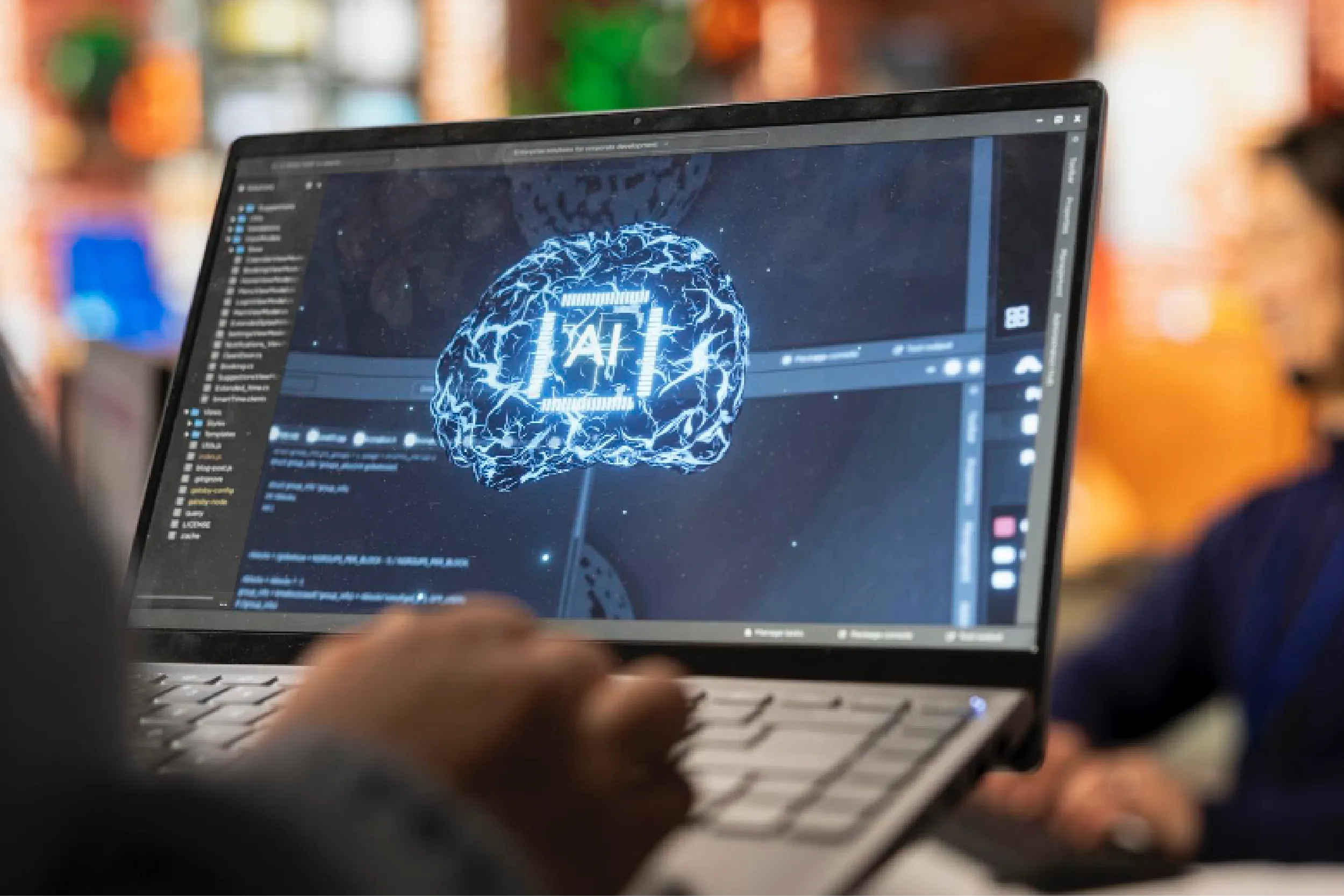 Laptop screen displays a blue neural-network brain visualization inside analytics software.